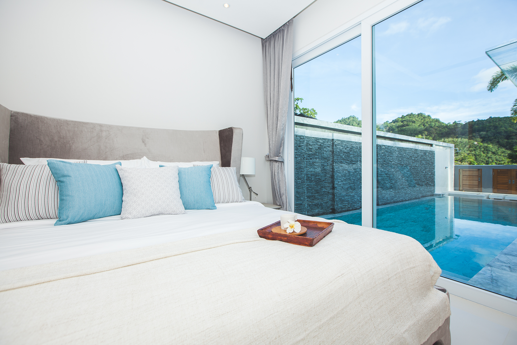 Modern comfortable, nicely decorated bedroom with pool view